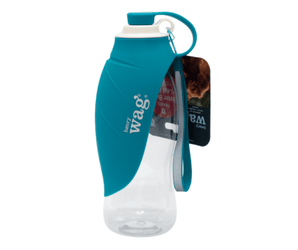 White background with a blue Henry Wag dog travel water bottle with a teal coloured overlapping 'leaf' bowl. Attached to a cardboard tag.