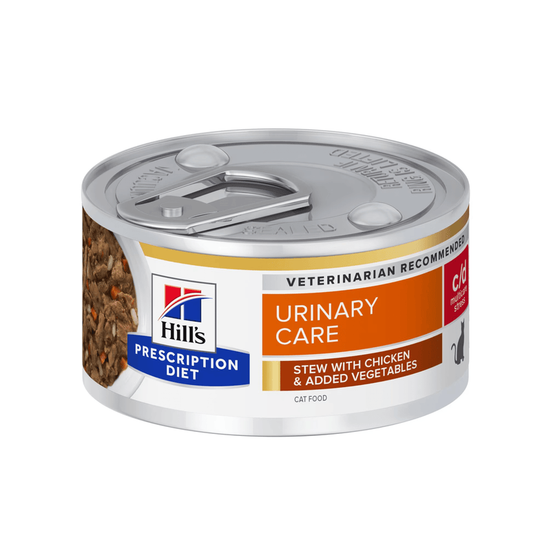 Hills Prescription cat food tin with a bowl full of food pictured on the label, text reads 'Urinary Care, C/D Multicare Stress' and 'Stew with chicken & added vegetables' on a white background. 