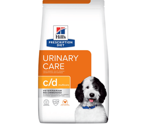 Hills Prescription Diet Urinary Care dry dog food packaged in a white bag with an adult black and white dog pictured on the bag. Text on bag says 'Hill's Prescription Diet, Urinary Care' and 'C/D Multicare, Veterinarian recommended' pictured on white background. 