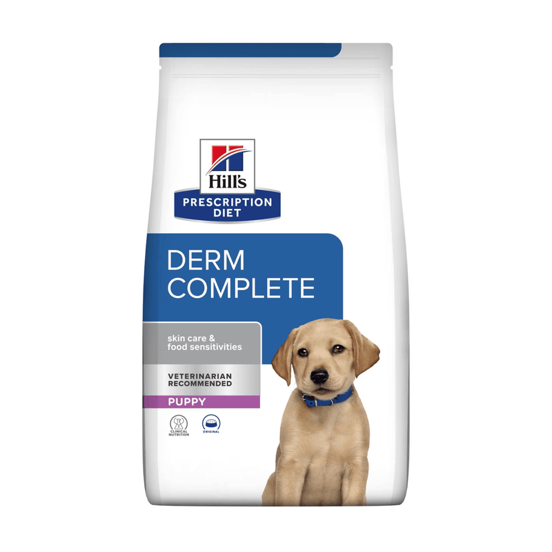 Hills Prescription Diet Derm Complete dry puppy food packaged in a white bag with a golden Labrador puppy pictured on the bag. Text on bag says 'Hill's Prescription Diet, Derm Complete' and 'Skin Care & Food Sensitivities, Veterinarian recommended, Puppy' pictured on white background. 