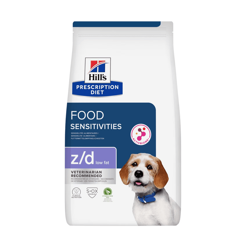 Hills Prescription Diet Food Sensitivities Low Fat dry dog food packaged in a white bag with a brown and white adult dog pictured on the bag. Text on bag says 'Hill's Prescription Diet, Food Sensitivities' and 'Z/D Low Fat, Veterinarian recommended' pictured on white background. 