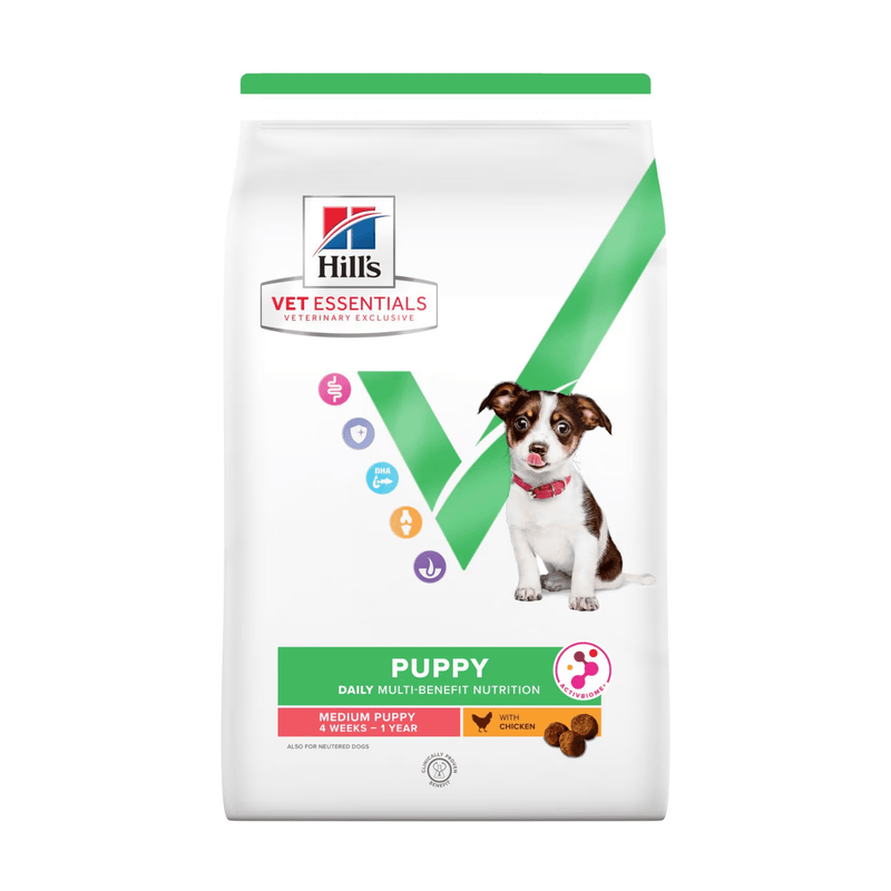 Hills Vet Essentials dry puppy food packaged in a white bag with a Jack Russell puppy pictured on the bag. Text on bag says 'Hill's Vet Essentials, veterinary exclusive' and 'Puppy, Medium, 4 weeks - 1year' with a chicken pictured with text 'with Chicken' beneath on white background. 