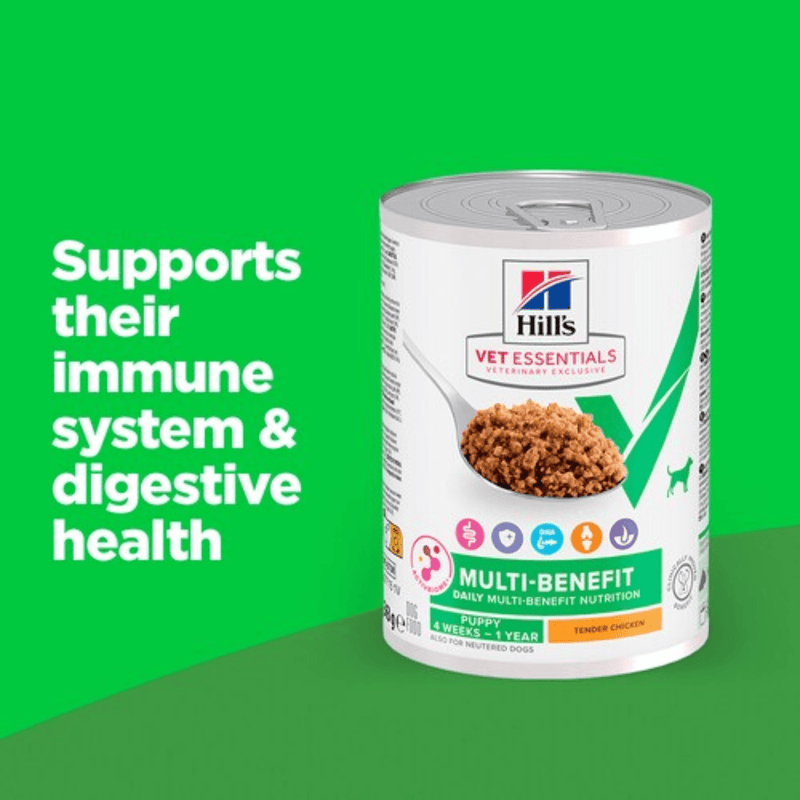 Picture of Hlls Vet Essentials dog tin with a spoon full of food pictured on the label, text reads 'Multi-Benefit, Puppy 4 weeks - 1 year' and 'Tender Chicken' on a green background with white text stating 'Supports their immune system & digestive health'.