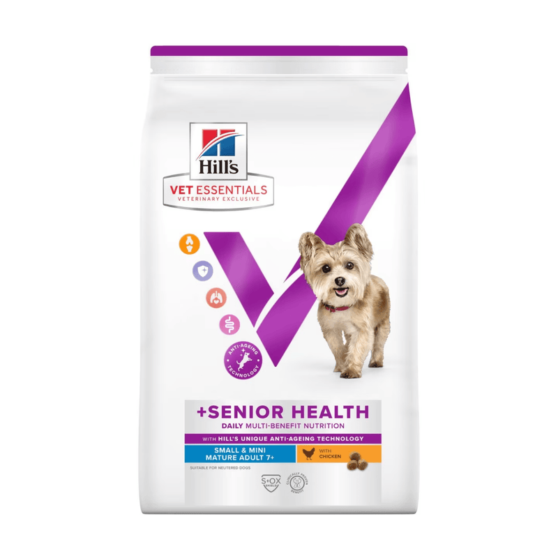 Hills Vet Essentials dry dog food packaged in a white bag with an small adult brown dog pictured on the bag. Text on bag says 'Hill's Vet Essentials, veterinary exclusive' and '+Senior Health, Small & Mini, Mature Adult 7+' with a chicken pictured with text 'with Chicken' beneath on white background. 