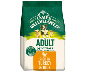 White background with a bag of James Wellbeloved Turkey & Rice Dog Food. Packaging is green and cream with 3 dogs pictured, with text 'Adult, Dog 1-7years, Turkey and Rice'. 