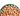 White background with close up of green bowl pictured filled with wet adult cat food.