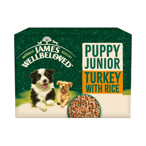 White background with a box of James Wellbeloved Turkey with Rice Puppy Wet Food. The box is green and cream with 2 puppies pictured on the box.