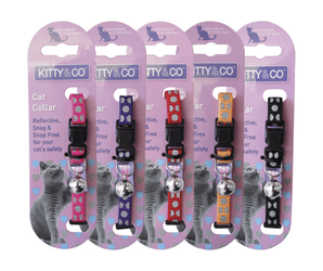 White background with five cat collars backed on lilac cardboard with text 'Kitty & Co, Cat Collar, Reflective, Snag, Snag free for your cat's safety' The sets are in pink, purple, red, orange and black. 