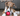 Brown and white boxer puppy playing with a KONG Classic ball in a living room environment. 
