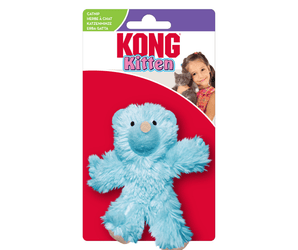 Fluffy blue teddy bear cat toy with stitched eye details and beige nose attached to white and red cardboard backing which pictures a girl holding a kitten, text at top reads 'KONG Kitten'.  