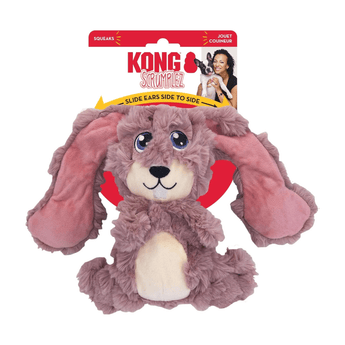 White background with a KONG Scrumples Bunny dog toy, the main body is made from faux fur body with a cream belly and muzzle with stitched features attached to a cardboard backing.