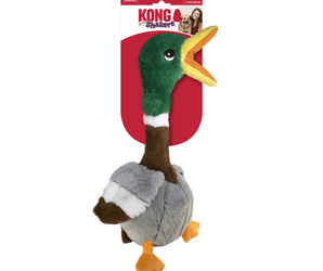 White background with a KONG Shakers Duck dog toy, with a long green and brown neck and grey body, yellow beak and legs with stitched features attached to a cardboard backing.