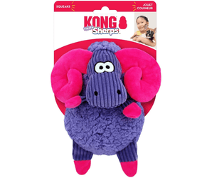 White background with a KONG Floofs Sherps Big Horn dog toy, the main body is made from purple sherpa with pink hooves and horns with stitched features attached to a cardboard backing.