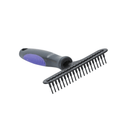 White background with a large black BUSTER Undercoat Rake Brush with fixed pins and purple grips laying on the pins.