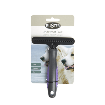 White background with a large black BUSTER Undercoat Rake Brush with fixed pins and purple grips on the handle attached to a cardboard backing. 