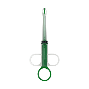 White background with a Kruuse syringe-type Tablet Introducer with a transparent outer layer and internal green plunger. 