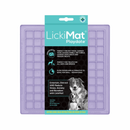 White background with a lilac LickiMat Playdate slow feeder mat with a square grid surface. The Playdate mat is in black and blue packaging cardboard packaging. 