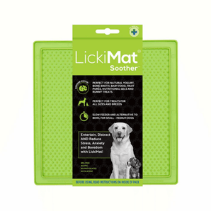 White background with a green LickiMat Soother slow feeder mat with a bobbly surface. The Soother mat is in black and green packaging cardboard packaging. 