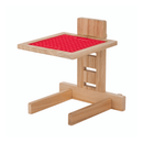 White background with a wooden LickiMat Classic Riser for LickiMats slow feeding mats. There is a red Playdate LickiMat on the riser to demostrate use. 