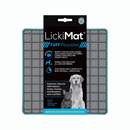 White background with a turquoise LickiMat Tuff Playdate slow feeder mat with a grey square grid surface. The Playdate mat is in black and blue packaging cardboard packaging. 