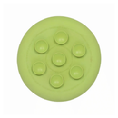White background with a base view of a green LickiMat UFO slow feeder bowl with suction cups on the base. 