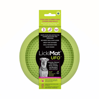 White background with a green LickiMat UFO slow feeder bowl with a bobbly internal surface. The UFO bowl is in black cardboard packaging. 