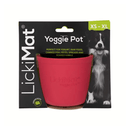 White background with a pink LickiMat Yoggie Pot slow feeder. The Yoggie pot is in black cardboard packaging. 