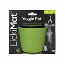 White background with a green LickiMat Yoggie Pot slow feeder. The Yoggie pot is in black cardboard packaging. 
