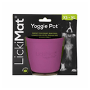 White background with a purple LickiMat Yoggie Pot slow feeder. The Yoggie Pot is in black cardboard packaging. 