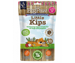 White background with a packet of Little BigPaw 'Little Kips' dog treats. Pictured on the packet is an illustration of a brown dog sleeping with a apples, berries, lemons and a jar of peanut butter in the foreground. Text on the bag says 'Chillaxing vegan treats for all dogs and puppies, 100% natural ingredients, soft & squidgy baked treats. Approx. 100 treats!' 