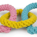 Close up of pastel pink, yellow and blue heart shaped rope dog toy.