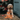 Cream coloured mixed breed dog with orange fox shaped dog toy with long arms and legs, white chin and stitched detail eyes, brown nose. Pictured outside on a patio, next to a shed with bushes in the background. 
