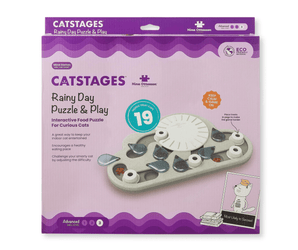 Nina Ottosson Catstages Rainy Day Puzzle & Play toy in its original retail packaging, featuring a purple and lavender box with an illustration of the cat-shaped puzzle piece set.