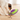 Jack Russell terrier dog playing with a purple and lime green Nina Ottosson Dog Treat Maze toy with dog treats shown spilled out.