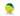 A yellow and blue Nina Ottosson Treat Tumble dog ball toy, pictured with treats pouring out on a white background.