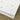 White paper with gold paw print and heart designs on a wooden surface