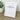 Framed print with 'Pawsitive vibes only' text on a wooden surface with a plant in the background
