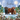 A festive Christmas illustration featuring three Highland cows in a snowy winter landscape with pine trees, falling snow, and a full moon. The text 'HAVE A LOVELY Christmas' is written at the top.