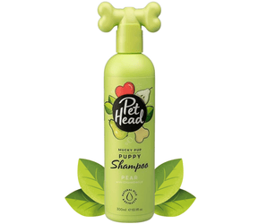 White background with a green bottle of Pet Head Mucky Pup shampoo for Puppies. On the bottle is illustrated pears, leaves and a dog bone with text 'Mucky Pup, Puppy Shampoo, Pear with Chamomile'. 