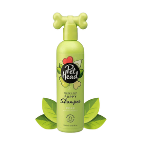 White background with a green bottle of Pet Head Mucky Pup shampoo for Puppies. On the bottle is illustrated pears, leaves and a dog bone with text 'Mucky Pup, Puppy Shampoo, Pear with Chamomile'. 