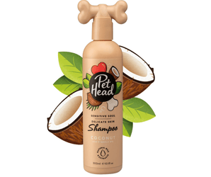 White background with a beige bottle of Pet Head Sensitive Soul shampoo for dogs. On the bottle is illustrated coconuts, leaves and a dog bone with text 'Sensitive Soul, Delicate skin, Shampoo, Coconut with Marula oil'. 