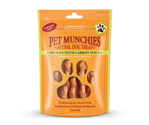 A stand-up pouch of Pet Munchies Chicken with Carrot sticks dog treats on a plain white background. The packaging is bright orange with a large paw-shaped window showing the chicken with carrot stick treats inside.