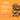 Promotional graphic for Pet Munchies Natural Pet Treats showing cubical sushi treat pieces on a bright orange background with product text promoting the features of the treats. 