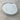A round silver metal keepsake tin lid with a white printed insert, photographed on a light gray stone surface. The insert includes fields for name, age, and imprint date, with paw prints and heart motifs, and the brand name 'Oh So Precious Pet Keepsakes' printed at the bottom.