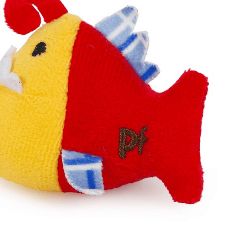 Close up of yellow and red Piranha cat toy with white felt teeth and blue fins with stitch detail on side of text 'PF' on a white background. 