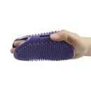 Hand inside purple grooming mitt on white background. 