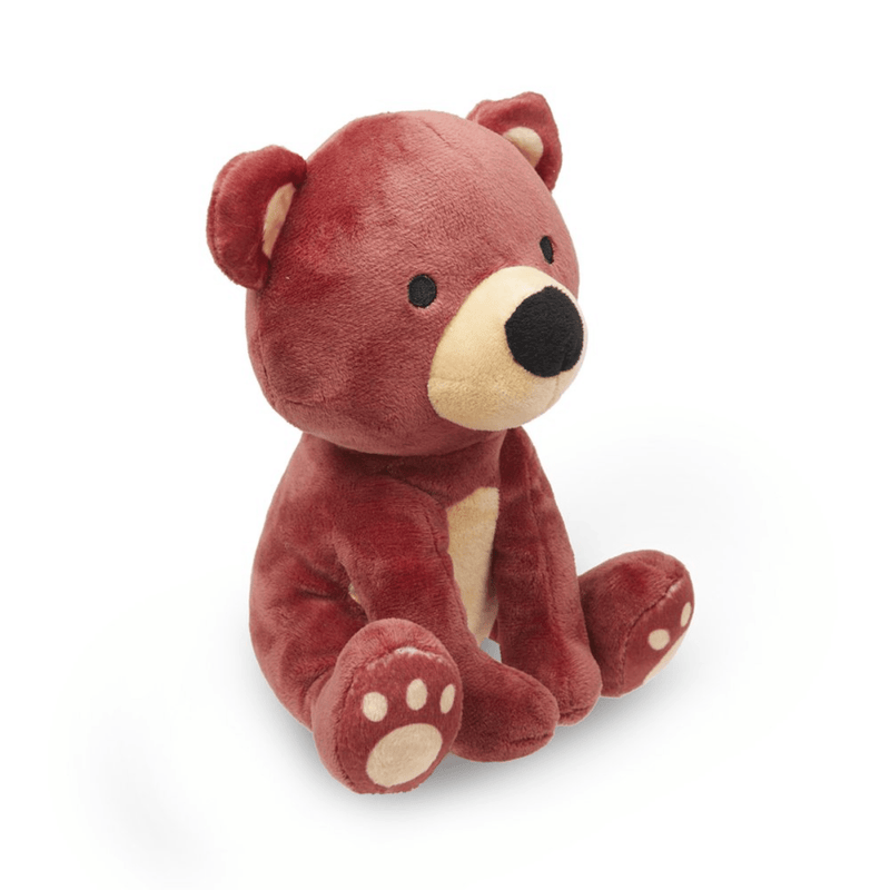 Side view of  a brown teddy bear dog toy with a cream muzzle, belly and paws sat on a white background. 