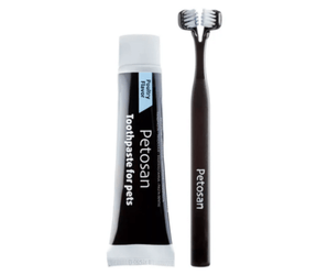 White background with a black doubled headed toothbrushes for dogs pictured next to a tube of Petosan Toothpaste for pets. 