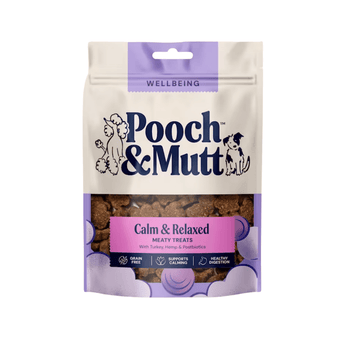 White background with a cream and purple packet of Pooch & Mutt dog treats. The text on the packet states 'Calm & Relaxed, Meaty Treats, with Turkey, Hemp & Postbiotics'.
