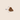 A small brown tooth-shaped treat or kibble piece centred on a light beige background, with a vertical measurement marker labelled 2.2cm beside it.
